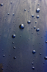 water drops on black with sky reflection
