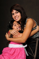 Obraz premium Young Girl and Teenager Embracing