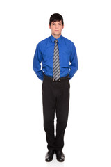 businessman standing with hands clasped behind his back