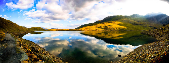 Beautiful wide view of welsh mountain range with blue lake and s