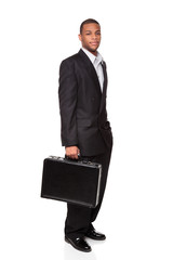 African American businessman isolated on white holding briefcase