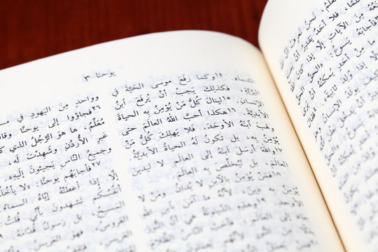 Arabic Bible open to Gospel of John. Focus on John 3:16