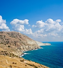 mountains near a sea coast under a clouds