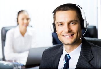 Two support phone operators at workplace