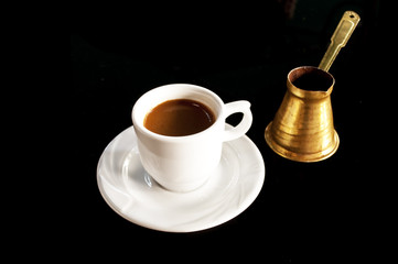 Cup of coffee with golden pot