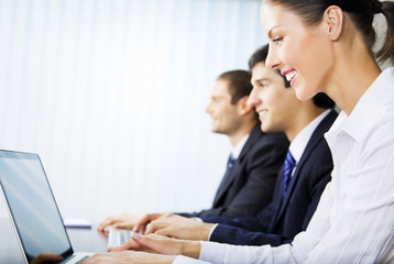 Fototapeta premium Three young successful businesspeople working at office