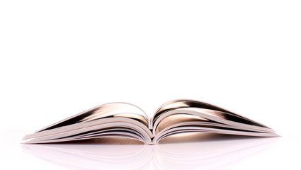Pile of open magazines isolated on white background