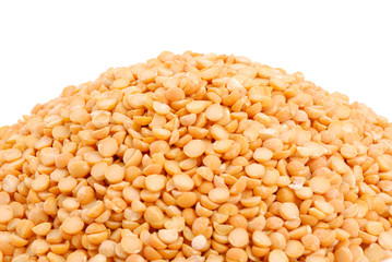 Pile of yellow split peas on white