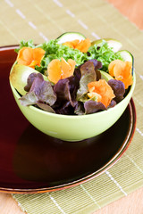 Floral salad with pansy, apple, zucchini and lettuce.