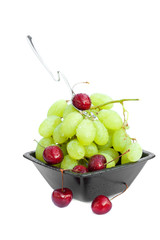 cup of grapes and cherries  isolated on white