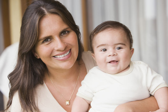 Hispanic woman holding baby boy