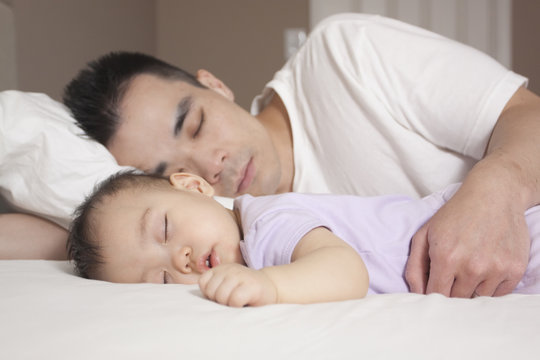 Chinese father and baby sleeping