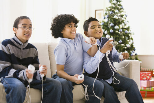 Boys playing video game at Christmas