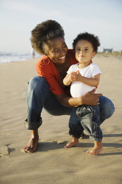 African mother on beach with son
