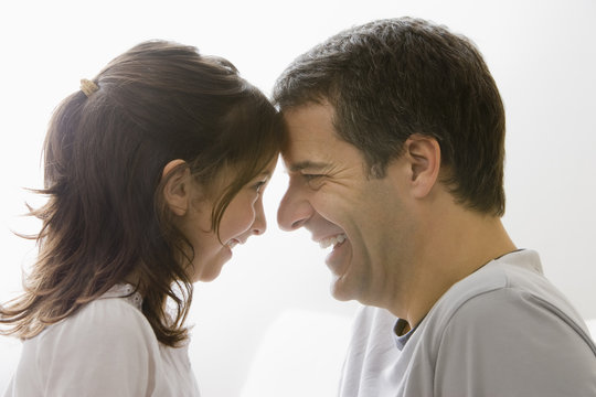 Hispanic father and daughter smiling