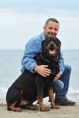 rottweiler et son maitre sur la plage