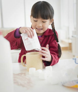 Chinese Girl Making Hot Chocolate