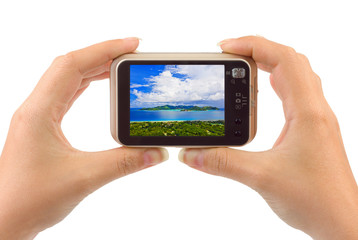 Hand with camera and beach landscape (my photo)