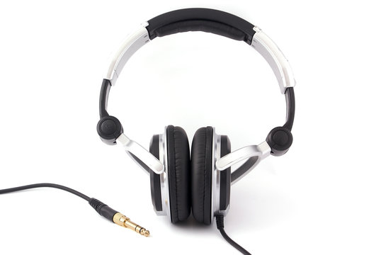 Headphones with gold plug on white background