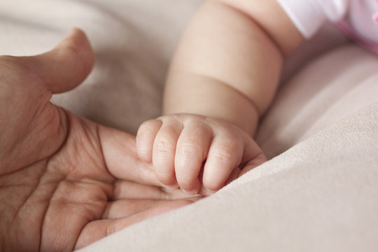 Chinese Father Holding BabyÕs Hand