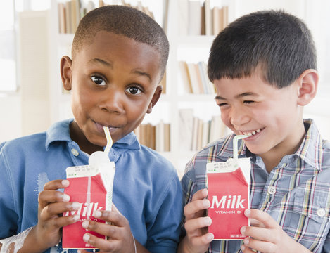 Boys Drinking Milk From Carton