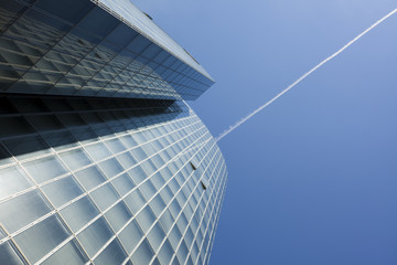 Obraz premium office building and contrail in the sky