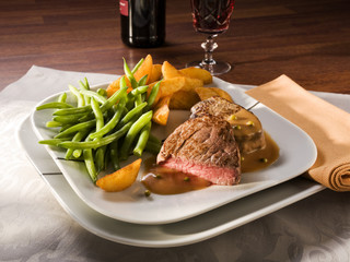 beef steak, green beans and potato wedges