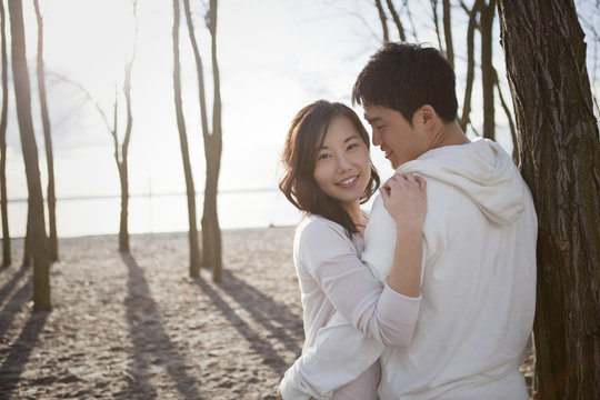Korean couple hugging outdoors