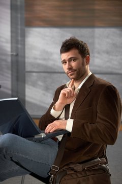 Portrait of man with laptop