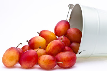 Plums spilling from a container