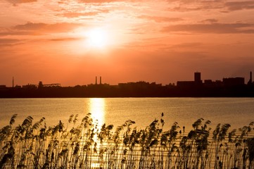 sunset on a river in a town