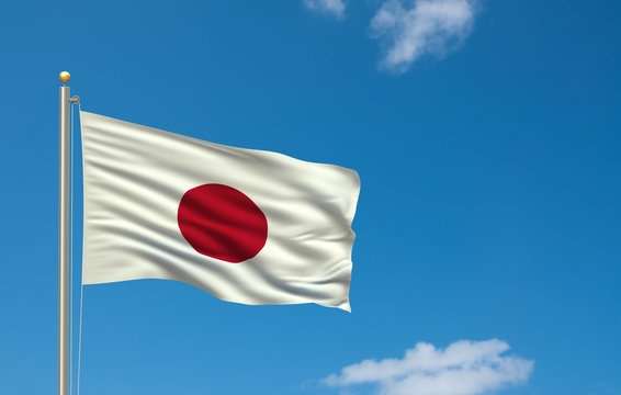 Flag of Japan waving in the wind in front of blue sky