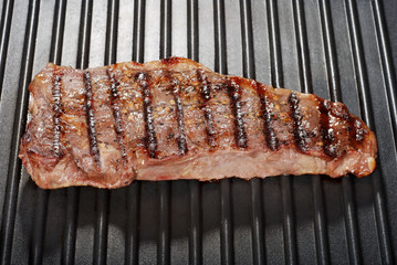 strip loin steak on a grill