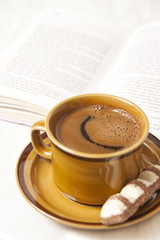 fresh cup of caffee on a tray with cookie