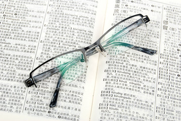 book and eyeglasses