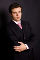 young businessman portrait on a black background