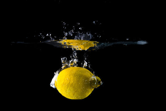 Lemon splash on black background