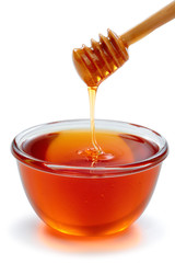 Wooden dipper with bowl of honey.