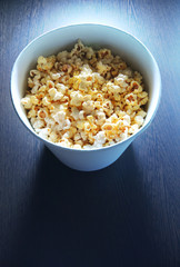 Popcorn bucket in front of TV light
