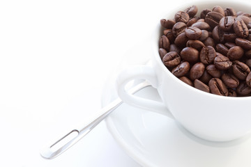 white cup with coffee beans