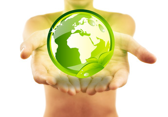 Hands holding earth with green leafs