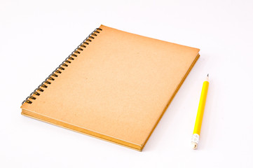 Brown Spiral Notebook with yellow pencil