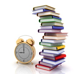 alarm clock near stack of books over white