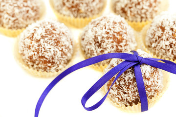 cake with coconut tied with ribbon isolated on white