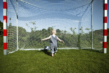 Little boy playing football