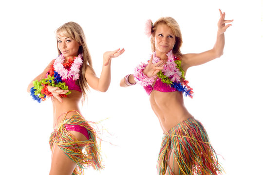 two pretty dancers in hawaiian costumes isolated