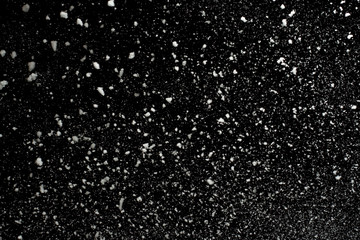 Flying snowflakes on black background