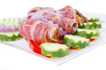 served meat rolls on white