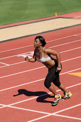 Young African American Woman Running on Track