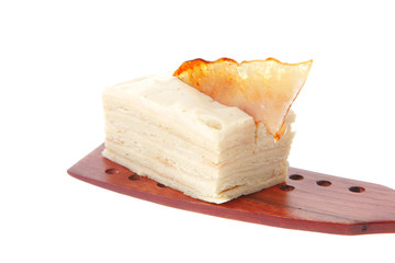 cream cake on wooden spatula